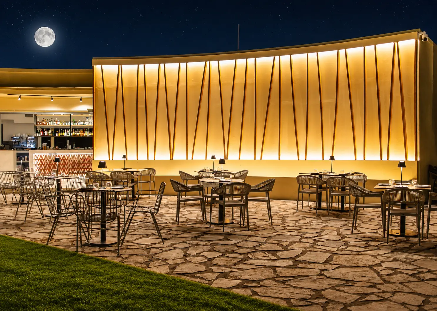OvO Piscine outdoor terrace at night under a full moon